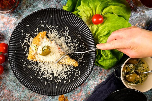 Delicious focaccia slice topped with cheese and olives on a stylish plate.